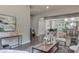 Open-concept living room featuring hardwood floors, modern decor, and seamless access to the adjacent dining and kitchen areas at 576 Quillian Ave, Decatur, GA 30032