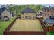 Wide angle view of a large backyard with lawn, fence, and houses nearby at 2580 Brittany Park Cv, Ellenwood, GA 30294