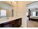 Main bathroom features marble countertops with double sinks and a view into the Primary bedroom at 2580 Brittany Park Cv, Ellenwood, GA 30294