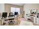 Bedroom or office space featuring a makeup vanity, two computer screens, and plush carpeting at 2580 Brittany Park Cv, Ellenwood, GA 30294