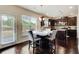 Bright breakfast nook with modern lighting, access to the backyard, and dark wood floors at 2580 Brittany Park Cv, Ellenwood, GA 30294