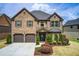 Beautiful two-story brick home with a well-manicured lawn and attached two-car garage at 2580 Brittany Park Cv, Ellenwood, GA 30294