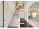 Bright foyer with staircase, hardwood floors, and views into dining area at 2580 Brittany Park Cv, Ellenwood, GA 30294
