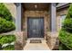 Inviting front entrance featuring a stylish door with sidelights and manicured landscaping at 2580 Brittany Park Cv, Ellenwood, GA 30294