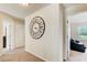 Hallway features neutral carpet, white walls, a decorative clock and open doors leading to other rooms at 2580 Brittany Park Cv, Ellenwood, GA 30294