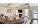 Spacious living room featuring coffered ceiling, fireplace, and access to the backyard at 2580 Brittany Park Cv, Ellenwood, GA 30294