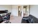 Office area with carpet flooring, computer and desk, and a partial view of a couch at 2580 Brittany Park Cv, Ellenwood, GA 30294