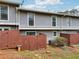 Townhome features a fenced-in backyard with a small patch of grass and minimal landscaping at 4988 Meadow Ln, Marietta, GA 30068