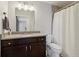 Bathroom featuring granite vanity, large mirror, modern lighting, and a tiled shower with curtain at 4988 Meadow Ln, Marietta, GA 30068