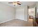 Bright bedroom features neutral paint, ceiling fan, carpet and closet for a clean modern feel at 4988 Meadow Ln, Marietta, GA 30068