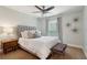 Well-lit bedroom with a stylish decor, featuring a plush bed, window with curtains, and an accent wall at 4988 Meadow Ln, Marietta, GA 30068