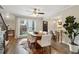 Inviting dining area showcasing hardwood floors, large window, and seamless flow to the kitchen at 4988 Meadow Ln, Marietta, GA 30068