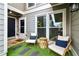 Charming entryway with artificial grass, outdoor seating, and a welcoming door at 4988 Meadow Ln, Marietta, GA 30068