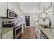 Updated kitchen featuring white subway tile backsplash, granite counters, and stainless appliances at 4988 Meadow Ln, Marietta, GA 30068