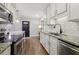 Modern kitchen features white cabinetry, granite countertops, stainless steel appliances, and wood-look flooring at 4988 Meadow Ln, Marietta, GA 30068