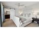 Bedroom with a large bed, stylish ceiling fan, barn-style door, and windows with curtains at 4988 Meadow Ln, Marietta, GA 30068