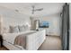 Bedroom features large bed, modern ceiling fan, dresser with television, bright windows, and curtains at 4988 Meadow Ln, Marietta, GA 30068