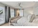 Bedroom with a large bed, stylish ceiling fan, barn-style door, and bright windows with curtains at 4988 Meadow Ln, Marietta, GA 30068