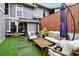 Cozy patio with artificial turf, wooden furniture, and a shaded umbrella for outdoor relaxation at 4988 Meadow Ln, Marietta, GA 30068