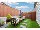 Inviting outdoor patio featuring stylish furniture, a wooden table and lush artificial turf at 4988 Meadow Ln, Marietta, GA 30068