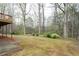 A well-maintained backyard features a concrete patio and leads into a woodsy area at 5233 Hayden Farms Dr, Powder Springs, GA 30127