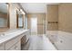 Bathroom featuring double sink vanity, soaking tub, tiled floors, and decorative wallpaper at 5233 Hayden Farms Dr, Powder Springs, GA 30127