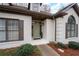 Close-up of a brick house entrance with beautiful windows and manicured landscaping details at 5233 Hayden Farms Dr, Powder Springs, GA 30127