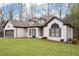 Well-maintained brick house boasts a lush lawn, inviting entryway, and convenient two-car garage at 5233 Hayden Farms Dr, Powder Springs, GA 30127