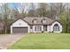Charming one story home with beautiful lawn, two car garage, and inviting curb appeal at 5233 Hayden Farms Dr, Powder Springs, GA 30127