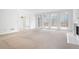 Open-concept living space with fireplace, large windows, and a view to the back deck at 5233 Hayden Farms Dr, Powder Springs, GA 30127
