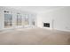 Spacious living room features a cozy fireplace and large windows with a view of the outdoors at 5233 Hayden Farms Dr, Powder Springs, GA 30127