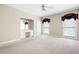 Spacious main bedroom featuring two windows, a ceiling fan, and a built-in vanity at 5233 Hayden Farms Dr, Powder Springs, GA 30127