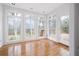 Bright sunroom with hardwood floors and large windows offering views of the backyard at 5233 Hayden Farms Dr, Powder Springs, GA 30127