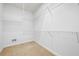 Walk-in closet features custom shelving and carpeted floors at 5233 Hayden Farms Dr, Powder Springs, GA 30127