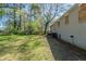 Large backyard featuring a spacious grassy area and an exterior view of the home at 388 Belgarde Se Pl, Atlanta, GA 30354
