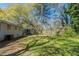 A grassy backyard is surrounded by mature trees, offering shade and privacy at 388 Belgarde Se Pl, Atlanta, GA 30354