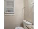 A simple bathroom features a toilet and a window, ready for a refresh at 388 Belgarde Se Pl, Atlanta, GA 30354