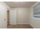 A light-filled bedroom with carpet and a door, offering a blank canvas for new owners at 388 Belgarde Se Pl, Atlanta, GA 30354