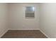 A clean bedroom features a window and carpeted floors, ready for personalization at 388 Belgarde Se Pl, Atlanta, GA 30354