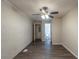 A bedroom featuring stylish plank floors, a painted brick accent wall, and a ceiling fan at 388 Belgarde Se Pl, Atlanta, GA 30354