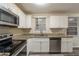 Updated kitchen features stainless steel appliances and granite countertops at 388 Belgarde Se Pl, Atlanta, GA 30354