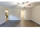 Open concept living room with hardwood floors, ceiling fan and open doorway to the kitchen at 388 Belgarde Se Pl, Atlanta, GA 30354