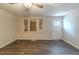 Bright living room featuring hardwood floors, ceiling fan and windows at 388 Belgarde Se Pl, Atlanta, GA 30354