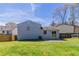 Spacious backyard with green grass, a small patio, and a partial fence for privacy at 5224 Sweet Air Ln, Stone Mountain, GA 30088