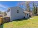 Exterior view of a home's backyard featuring a well-maintained lawn and partial fencing at 5224 Sweet Air Ln, Stone Mountain, GA 30088
