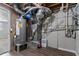 Basement mechanical area featuring a water heater, HVAC system, and exposed ductwork and plumbing at 5224 Sweet Air Ln, Stone Mountain, GA 30088