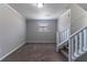 This finished basement has carpet flooring, neutral walls, stairs, and a window offering natural light at 5224 Sweet Air Ln, Stone Mountain, GA 30088