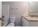 Bathroom featuring a granite vanity, toilet, and tub shower with modern fixtures at 5224 Sweet Air Ln, Stone Mountain, GA 30088