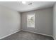 This bedroom features neutral walls, carpet flooring, and a window with blinds for natural light at 5224 Sweet Air Ln, Stone Mountain, GA 30088