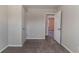 Bedroom with neutral walls, carpet flooring, and a view through an open door to the hallway at 5224 Sweet Air Ln, Stone Mountain, GA 30088